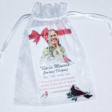 Funeral souvenir card and pin in a bag